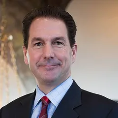 Joseph J. Jachetti, associate attorney at Schuster Law, in a dark suit and light blue shirt