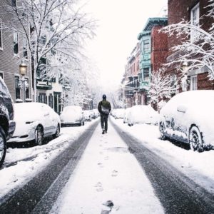 walking down snowy street in the city