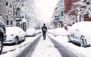 walking down snowy street in the city