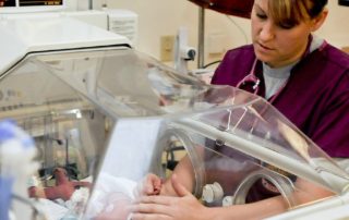 nurse caring for a newborn